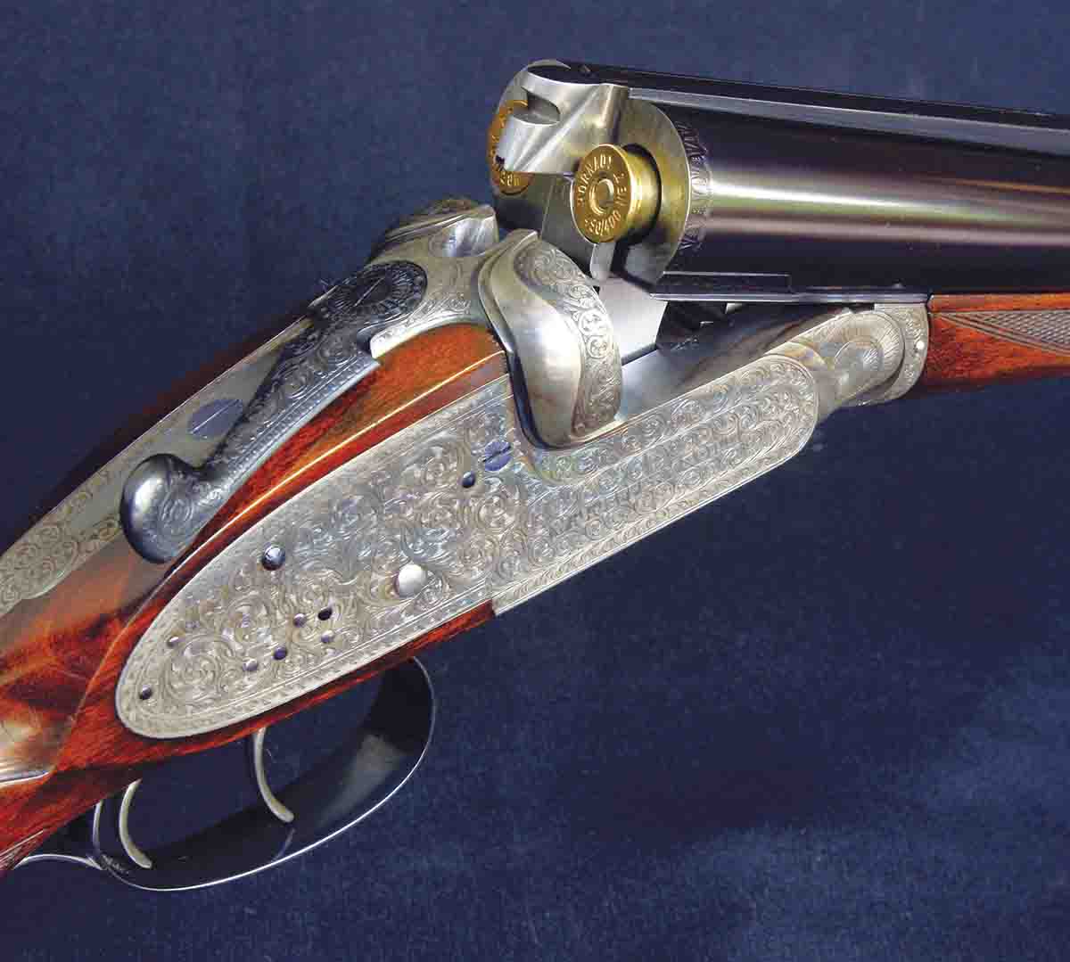 This W.J. Jeffery sidelock in .450/.400 Nitro Express (3-inch) is an unqualified London “best” and has one of the most elaborate doll’s head third bites. A sliding bolt coming out of the standing breech locks into the upper recess in the doll’s head, while the groove along the bottom is a guide for the extractors.